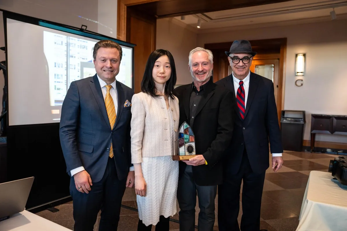 Epoch Times senior editor Jan Jekielek and reporters Eva Fu and Dan Berger pose with Brad Pomerance, awards coordinator for the Religion Communicators Council.